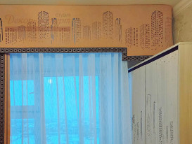 Фото правого фрагмента штор с перфорированным ламбрекеном и отделкой декоративным бордюром в комнате девочки.